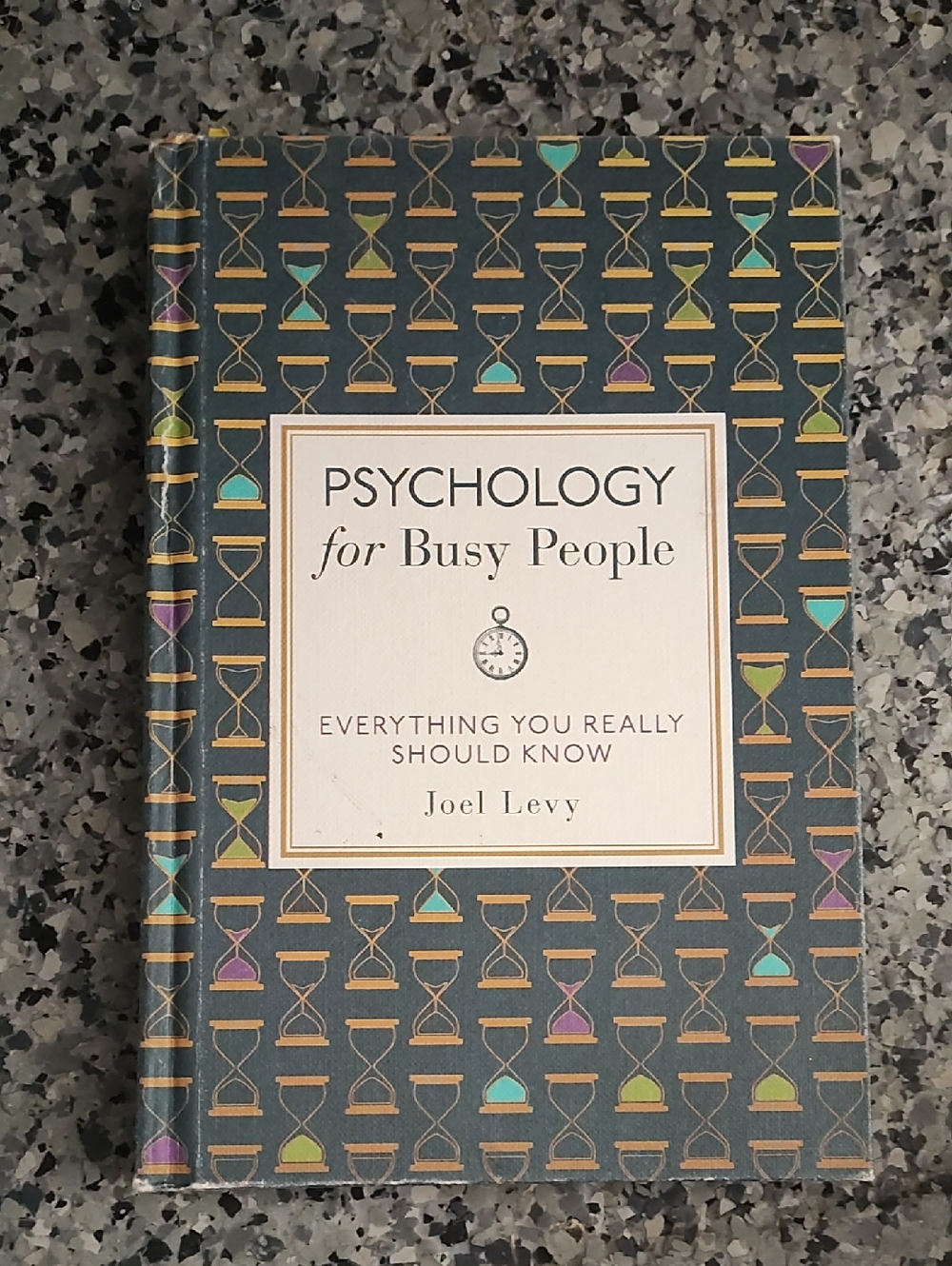 Psychology for Busy People by Joel Levy — Gray Cover with Multicolor Hourglasses
